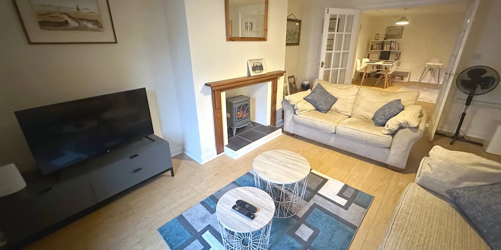 The lounge at The Studio, with a fireplace, two sofas and a big TV